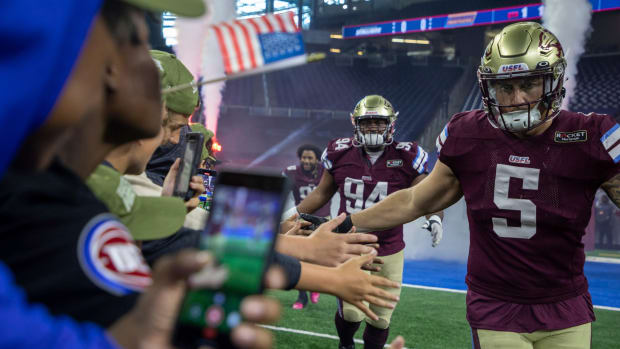 Fans greet Michigan Panthers Jamal Milan (94), Frank Ginda (5) and their teammates as they walk into the field before the start of their game against the Birmingham Stallions at Ford Field in Detroit on Saturday, May 20, 2023.  